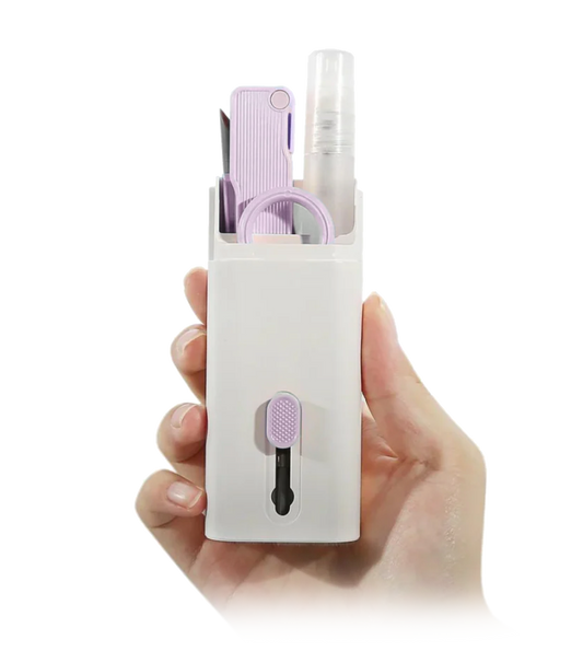 Hand holding a white travel-sized grooming kit with purple accents on a white background